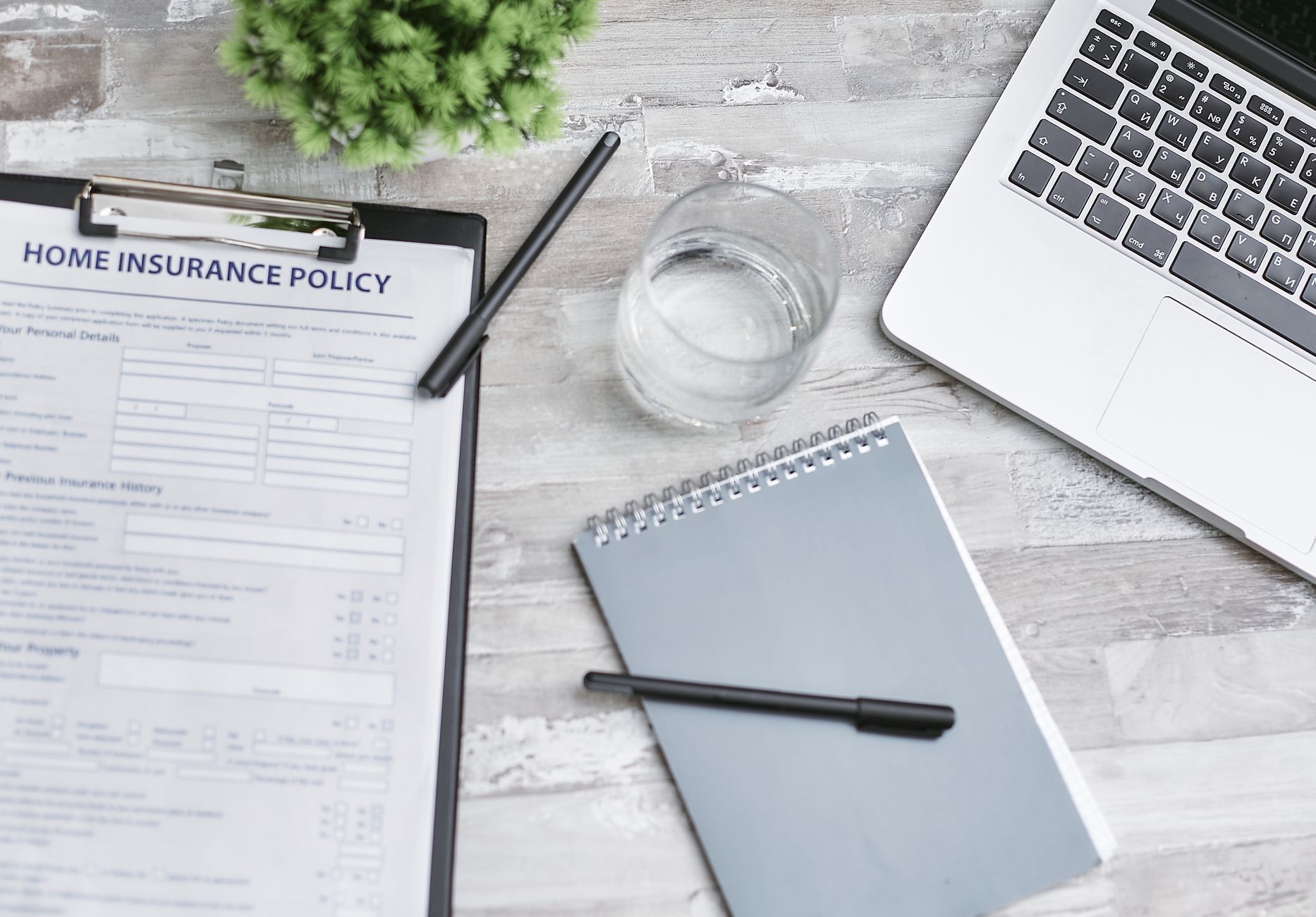 Insurance policy paperwork and a coffee mug on a kitchen table