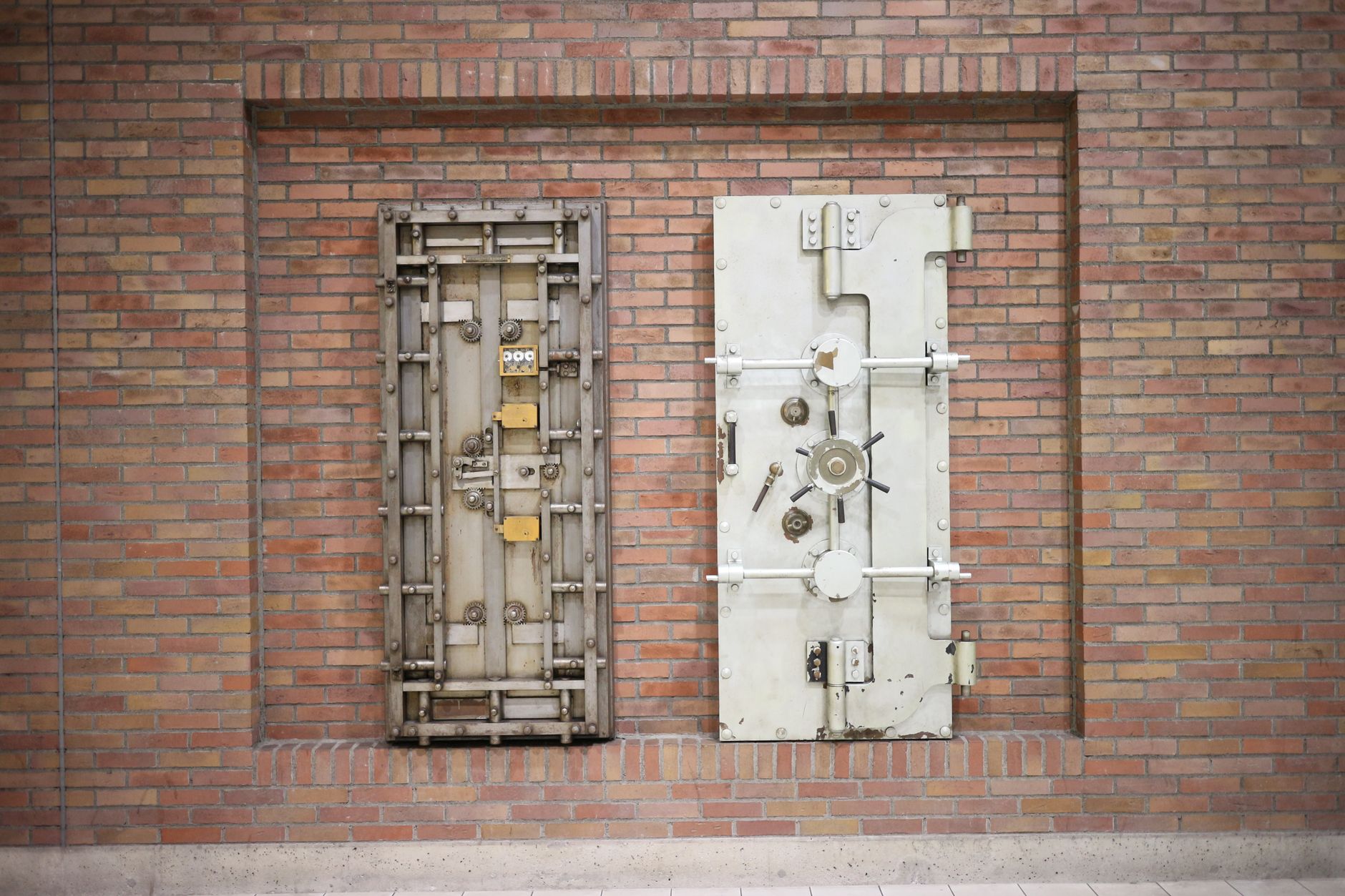 A heavy bank vault door slightly open with light coming through the gap